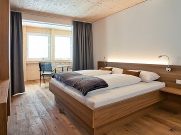 Schlafzimmer in den Rössle Appartements in Faschina